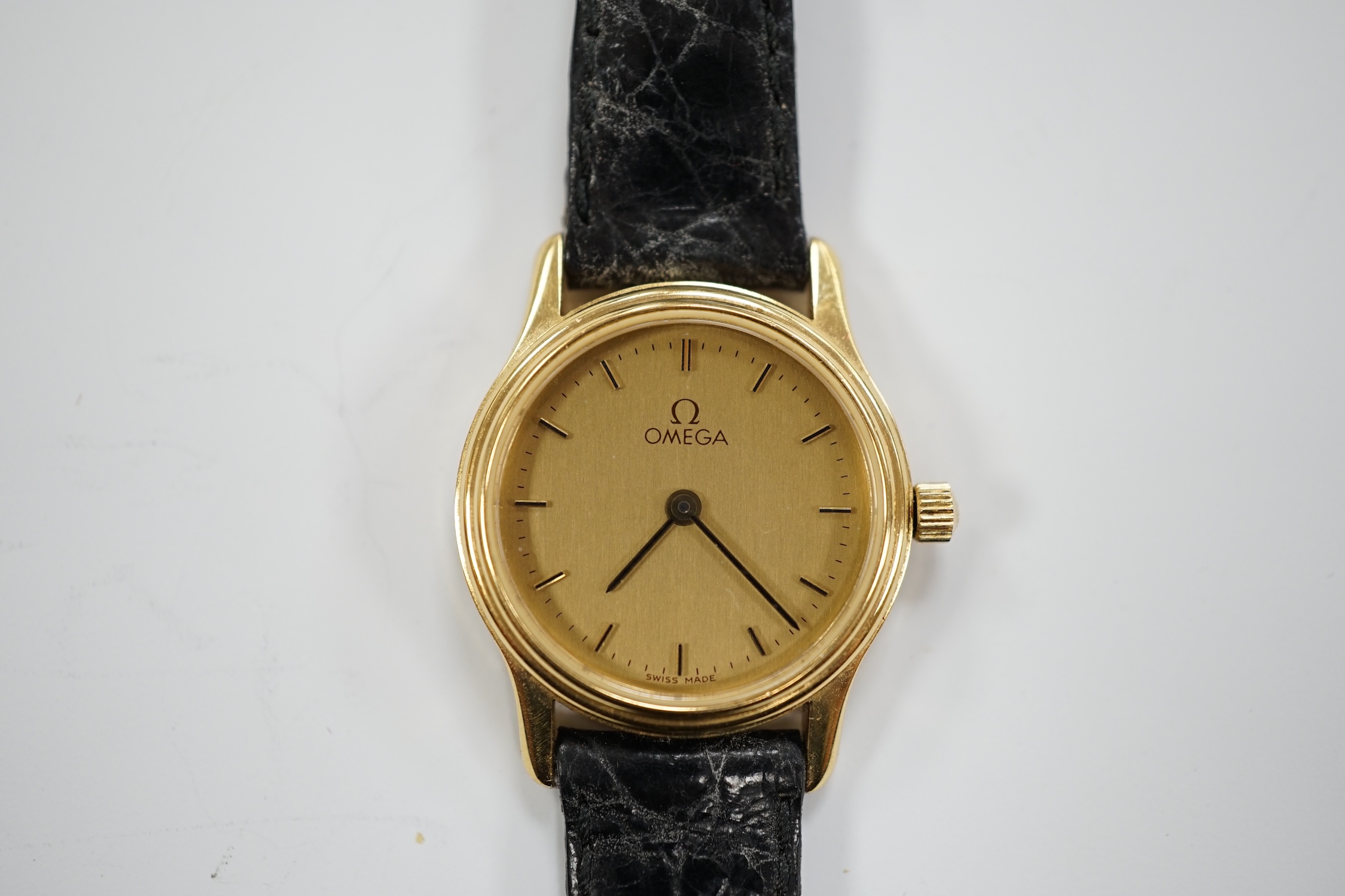 A lady's 18ct gold Omega quartz wrist watch, with case back inscription, on a leather strap with Omega buckle, with Omega box.
